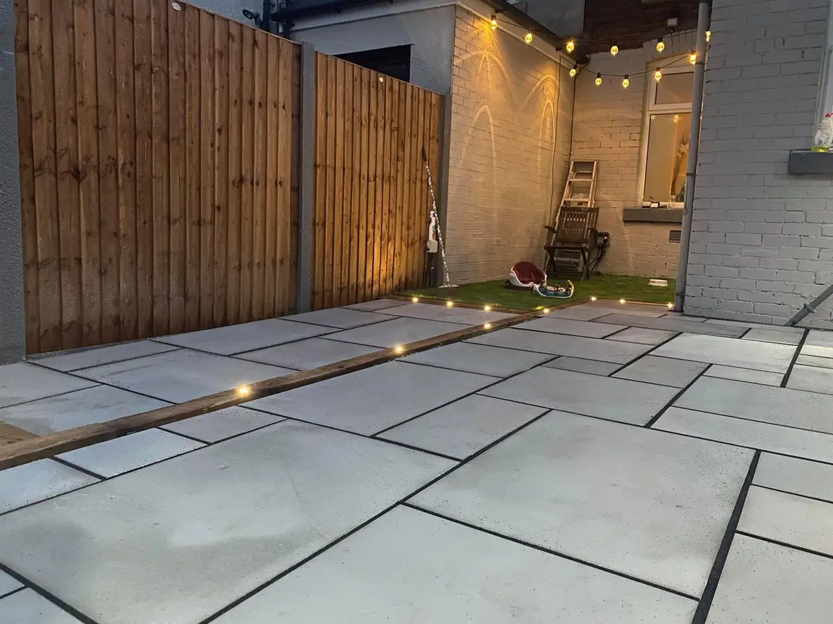 Courtyard patio with lights set into the paving and festoon lights above
